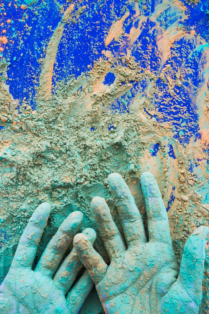 close-up-hand-painted-with-holi-color-powder-blue-background-min close-up-hand-painted-with-holi-color-powder-blue-background-min